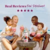 A smiling family sitting outdoors near the ocean enjoys berry smoothies together while a bottle of Smartfruit Blooming Berry purée mix sits on a table in front of them. Text above reads “Real Reviews, Real Refreshment” with five stars.