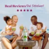 A smiling family sitting outdoors near the ocean enjoys green smoothies together while a bottle of Smartfruit Harvest Greens purée mix sits on a table in front of them. Text above reads “Real Reviews, Real Refreshment” with five stars.