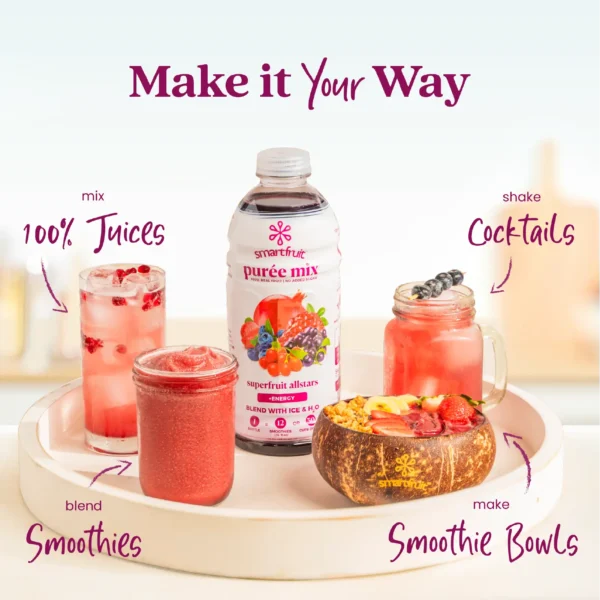 A Smartfruit Superfruit Allstars purée mix bottle displayed on a white tray surrounded by berry drinks and foods including a fresh juice with pomegranate seeds, a smoothie, a cocktail with berries, and a smoothie bowl topped with fruit and granola. Text highlights different uses: 100% juices, smoothies, cocktails, and smoothie bowls.