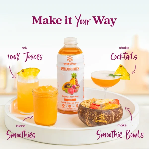 A Smartfruit Tropical Harmony purée mix bottle displayed on a white tray surrounded by tropical drinks and foods including fresh juice with a pineapple garnish, a smoothie, a tropical cocktail, and a smoothie bowl topped with fruit and granola. Text highlights different uses: 100% juices, smoothies, cocktails, and smoothie bowls.