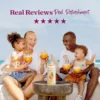 A smiling family sitting outdoors near the ocean enjoys tropical pineapple drinks together while a bottle of Smartfruit Aloha Pineapple purée mix sits on a table in front of them. Text above reads “Real Reviews, Real Refreshment” with five stars.