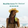 A woman wearing a straw hat stands on the beach while drinking a bright yellow refresher through a straw. Text above reads “Real Reviews, Real Refreshment” with five stars.