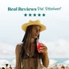 A woman wearing a straw hat stands at the beach while drinking a bright red refresher beverage through a straw. Text above reads “Real Reviews, Real Refreshment” with five stars.