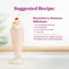 A creamy strawberry banana milkshake served in a tall milkshake glass topped with whipped cream, colorful sprinkles, and a cherry. Text shows a suggested recipe for a Strawberry Bananza Milkshake made with Strawberry Bananza purée mix, whole milk, vanilla ice cream, and ice.