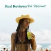 A woman wearing a straw hat stands at the beach while drinking a bright lemonade refresher through a straw. Text above reads “Real Reviews, Real Refreshment” with five stars.