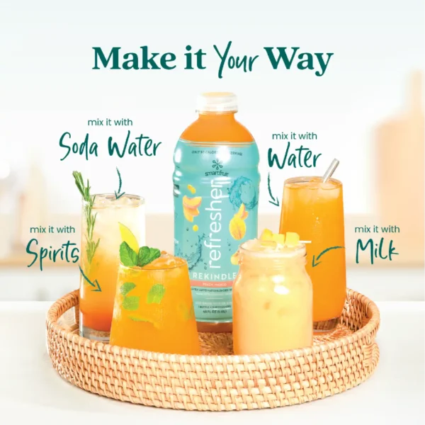 A Smartfruit Rekindle Refresher bottle placed on a woven tray surrounded by different drink options including a refresher with soda water, water, milk, and a cocktail with herbs and citrus garnish. Text highlights ways to mix the product including soda water, water, milk, and spirits.